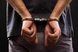 Man in handcuffs representing domestic violence and harassment 